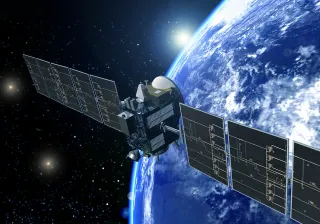A satellite in space orbiting around earth.