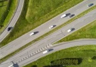 Photo of a truck driving down the motorway in the sunset