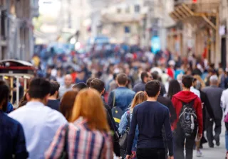 Lots of people walking down a busy city street