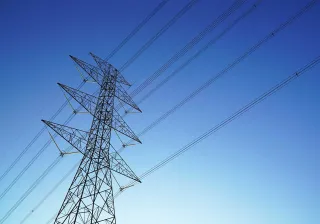 Electricity power lines in front of sundown