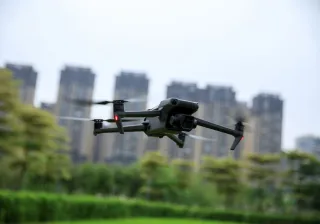 Photo of a drone flying over a city