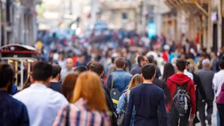 Lots of people walking down a busy city street