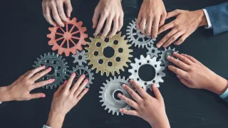 Cogwheels in hands