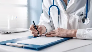 A doctor writing