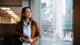 Photo of a woman looking out of a window