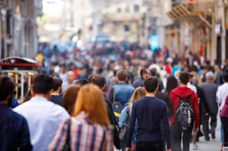 Lots of people walking down a busy city street