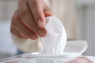 Hand taking out a tissue from a box