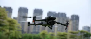 Photo of a drone flying over a city